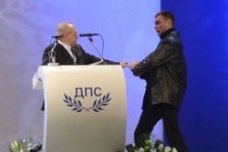 image: Oktai Enimehmedov attacks Ahmed Dogan as he delivers a speech in Sofia