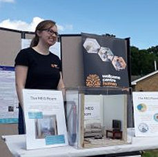 An image of a Steph Mellor, OPM team member with banners at young epilepsy open day