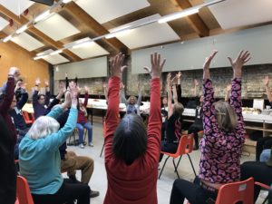 An image of people with hands up