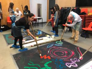 An image of people drawing an artwork