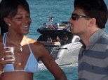 Is it all getting a bit boring, Leo? DiCaprio looks disinterested as a bikini-clad Naomi Campbell chatters to him on a yacht 