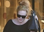 Going incognito: Adele covered up in a loose-fitting black smock and leggings as she stepped out in West Hollywood on Monday 